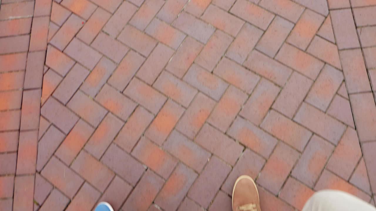 Legs of two man as walking on the street or pavement