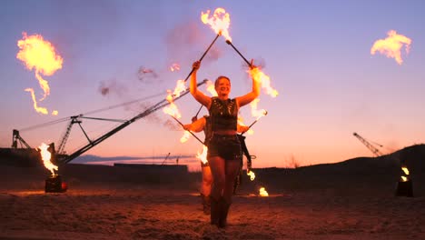 fire show. a group of professional artists performs a variety of fire facilities. boys and girls performed dances with fire in the night on the street in the park.