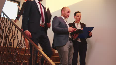 business team walking on stairs meeting colleagues working