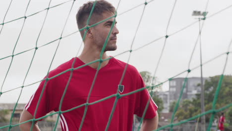 a young soccer player standing in a goal post