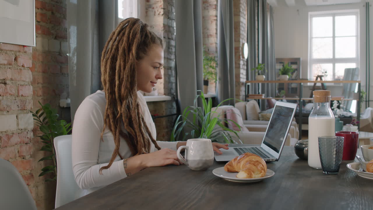 Pretty Woman With Laptop Having Breakfast
