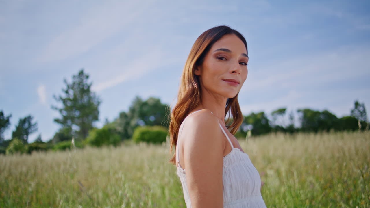 Gentle lady enjoying bloom at spikelets nature closeup. Woman touching hair