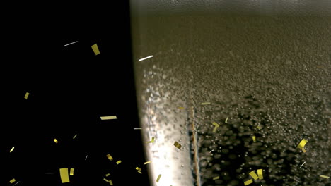 animation of gold confetti falling and bubbles rising in glass of champagne on black background