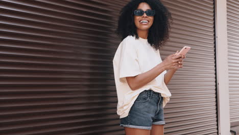 stylish woman using phone outdoors