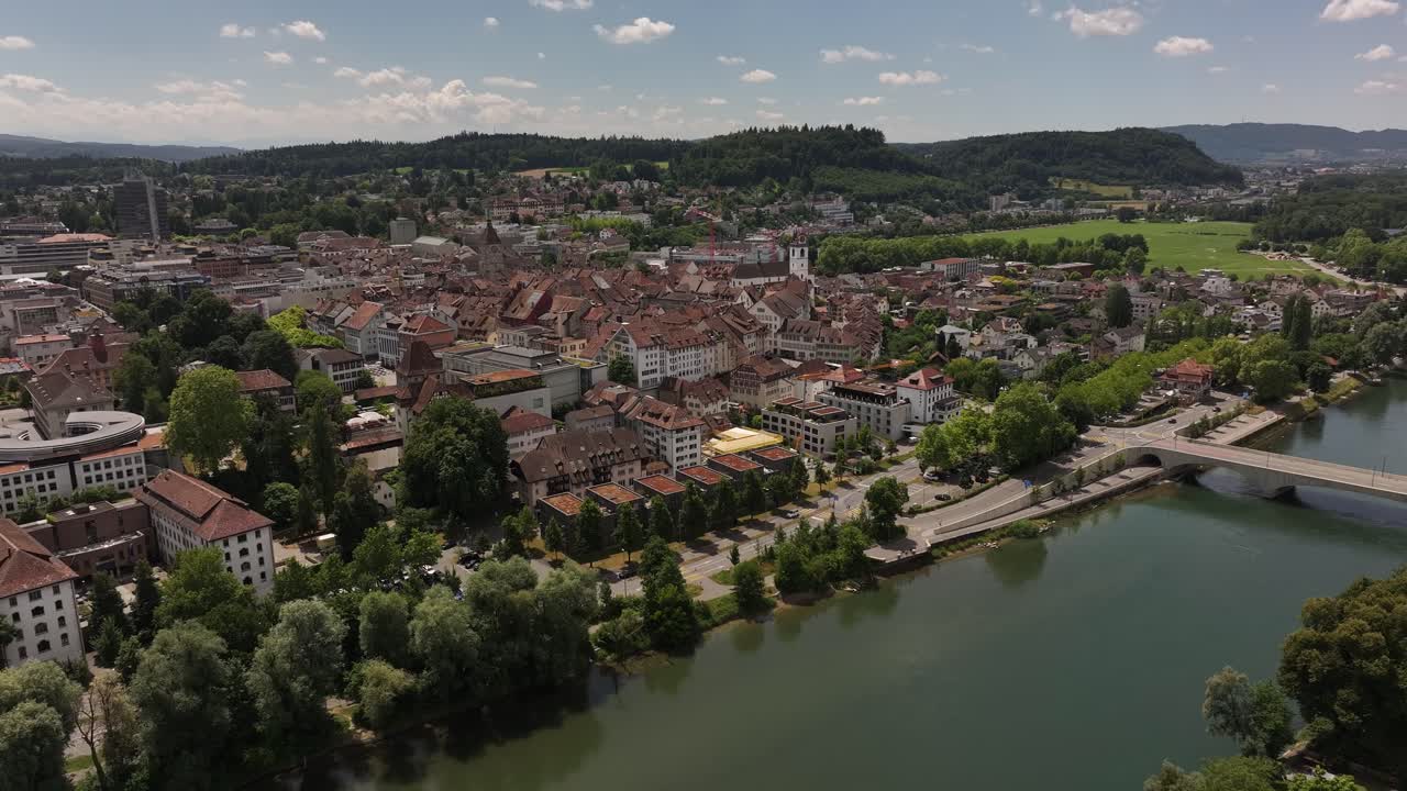 Luftfoto af Aaraus gamle bydel og flodbro omgivet af grønne bakker i Aargau, Schweiz.