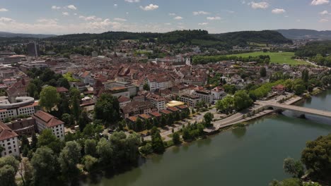 aerial view of aarau old town and river bridge surrounded by green hills in aargau, switzerland