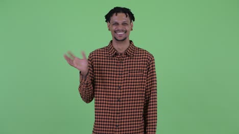 happy young handsome african man with dreadlocks