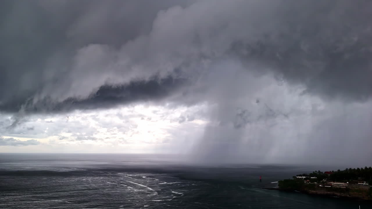 A heavy storm is raging over Senggigi Beach, dark rain clouds are descending
