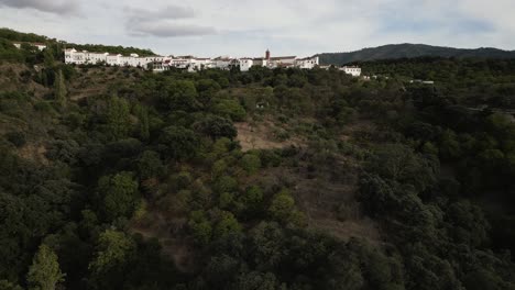 Forestry-mountains-and-white-colorful-village-in-Spain,-aerial-view