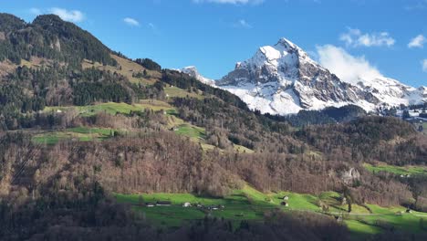 vista aérea de la aldea de weesen en suiza con una majestuosa montaña cubierta de nieve en el fondo