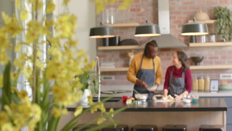 happy diverse couple in aprons baking in kitchen, copy space, slow motion