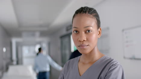 african american nurse stands confidently in a hospital corridor