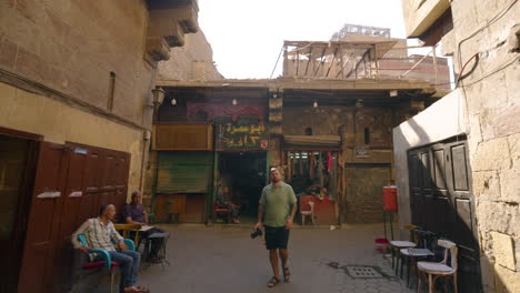 man taking pictures of old and ancient buildings from the streets of cairo, egypt. - closeup shot