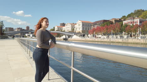 woman by the river in an urban setting