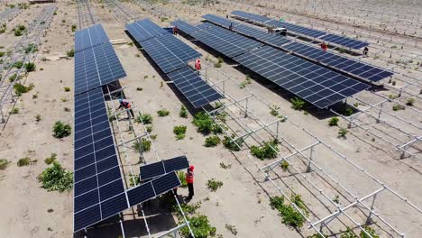 aerial view of african engineers installing new solar panels at power plant under construction in jambur, gambia