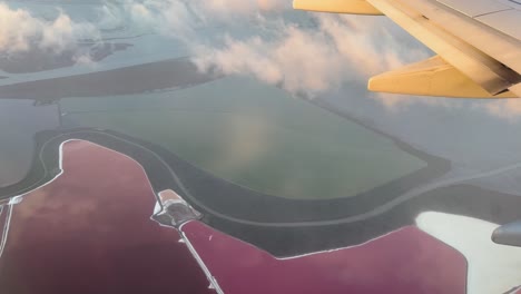 the view over wild life reserve, don edwards san francisco bay, from the plane with on of wing motors in sight