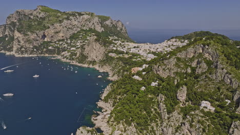 capri italy aerial v7 cinematic drone fly along the sea capturing idyllic charm of coastal beauty, rugged cliffside neighborhoods and quaint island town in summer - shot with mavic 3 cine - may 2023