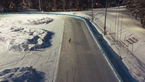 Two-ice-skaters-compete-on-rink,-Zakopane-in-Poland