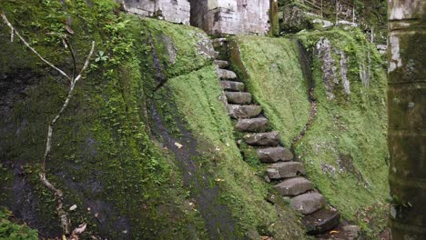 ancient ruins stone stairs and mystical gate at goa garba temple, bali, indonesia, archaeological site in tampaksiring gianyar from 12th century