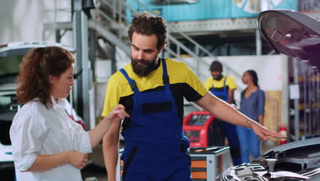 mechanic showing customer car damages