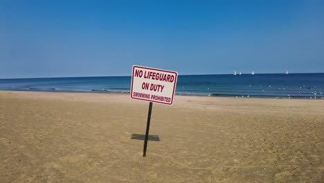 no lifeguard sign on an empty beach at sodus point new york vacation spot at the tip of land on the banks of lake ontario