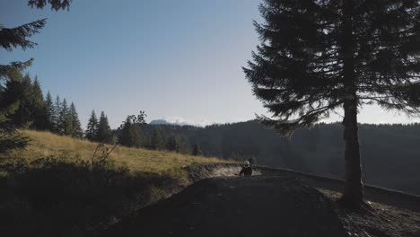 mountain biker setting up then riding down a trail