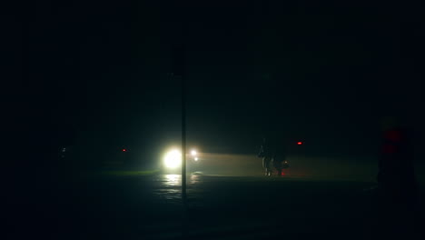 person walking on a street at night