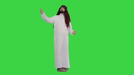 arab man wearing keffiyeh making wellcome gesture on a green screen, chroma key