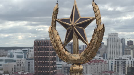 gold star ornament on a building with cityscape view