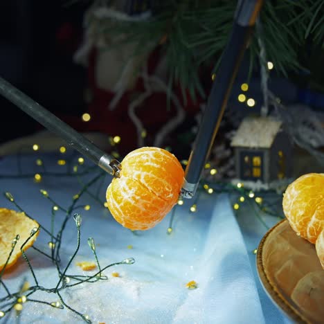 robotic arms of surgery machine hold the peeled tangerine. fruit peeled by the high-precised surgical equipment. christmas ornaments at the backdrop