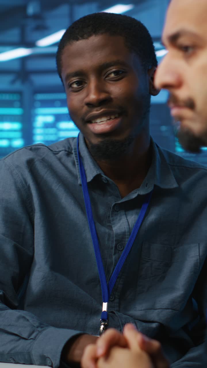 African American Man Listening and Smiling in a Server Room