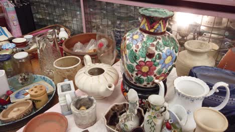 close up shot at vintage tea pottery, plates and glasses at flea market store