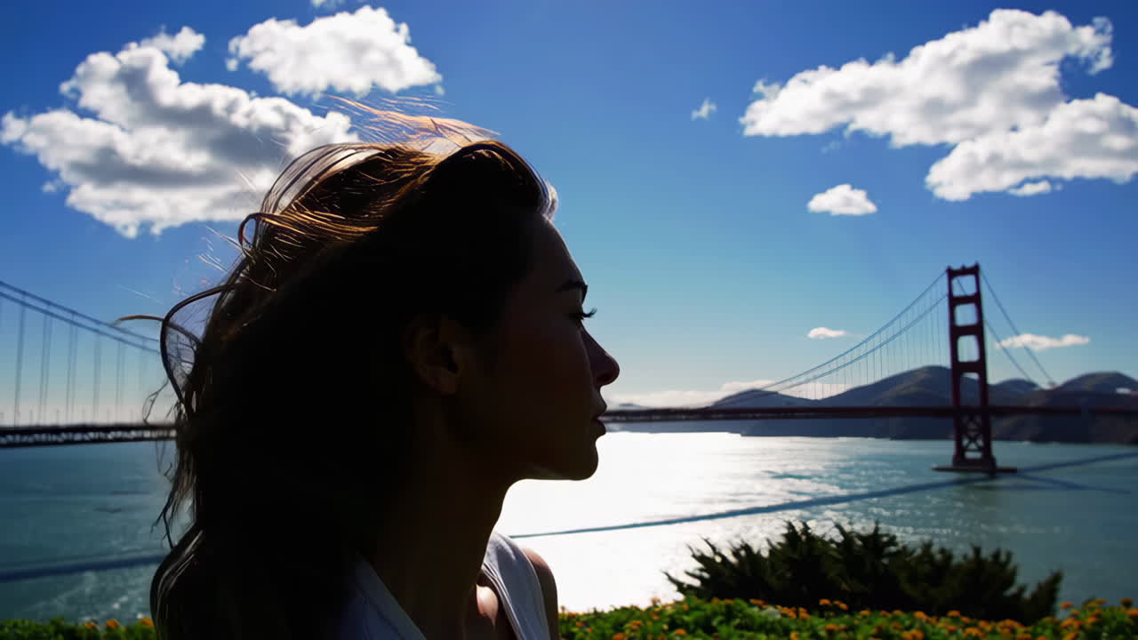 Woman in silhouette admiring the Golden Gate Bridge