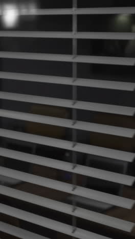 looking through blinds at a quiet modern space in the evening light