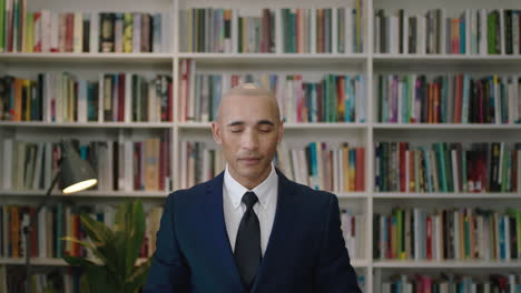 portrait of mature confident hispanic businessman looking at watch waiting in office library