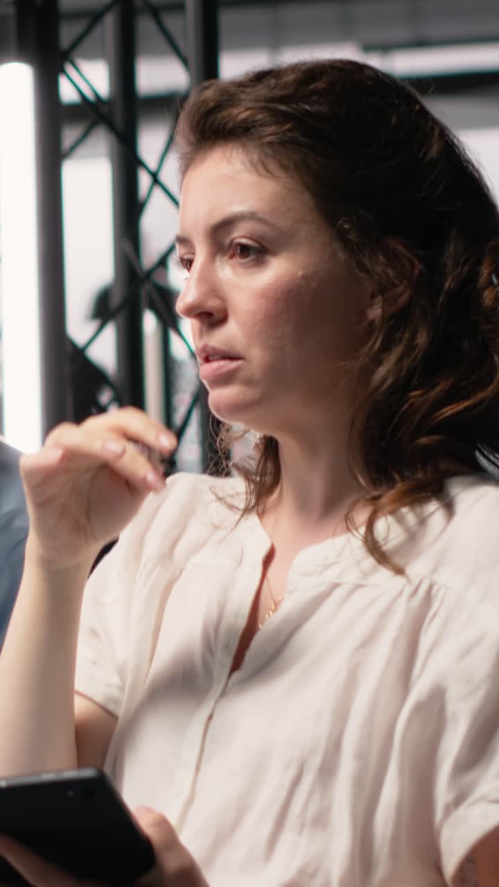 Vertical Video Diverse colleagues review structural plans for a property investment