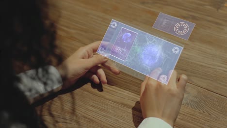 hands hold tablet with mechanical clock