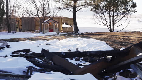 damaged home backyard rubble and remains in superior colorado boulder county residential area usa after marshall fire wildfire disaster.