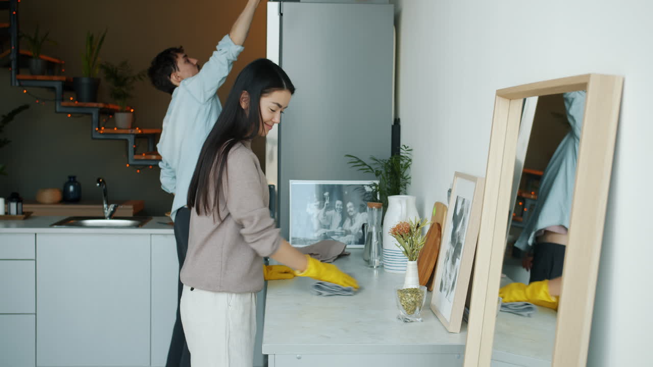 Couple Cleaning Their Kitchen