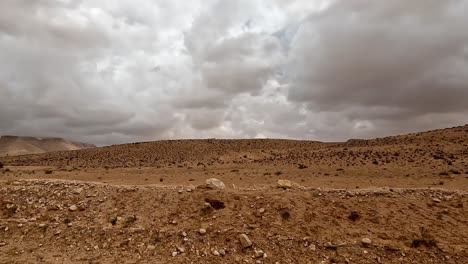 personal perspective driving along remote and solitary tunisia desert road with dramatic sky above, car passenger point of view