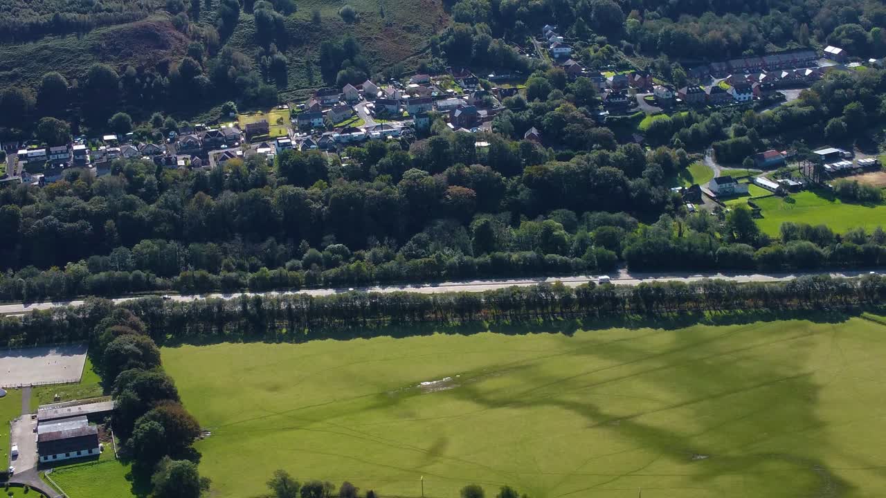 Aerial Travelling Sideways Looking Towards Busy Dual Carriageway with Surrounding Houses on Heads of the Valleys Road A465 Linking Valley Communities. Drone Video in South Wales