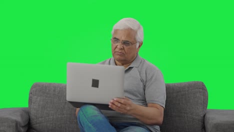 Indian-old-man-working-on-laptop-Green-screen