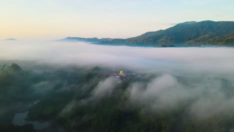 aerial view. flying over the village and fog in the morning. dramatic and beautiful