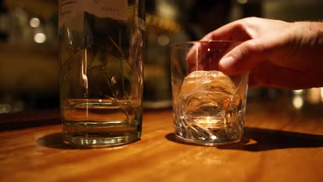 sequence of an ice cube falling into a glass