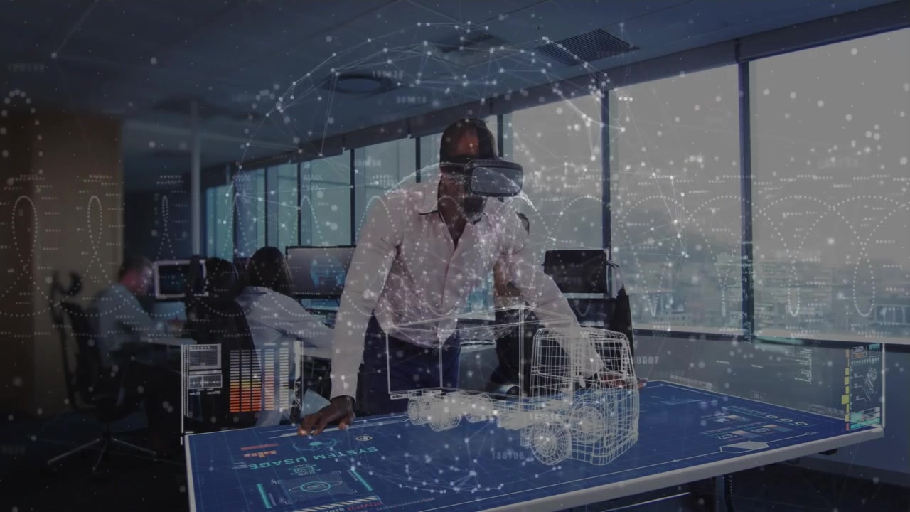 Standing man using VR headset manipulating 3D truck on table in office, displaying data overlays