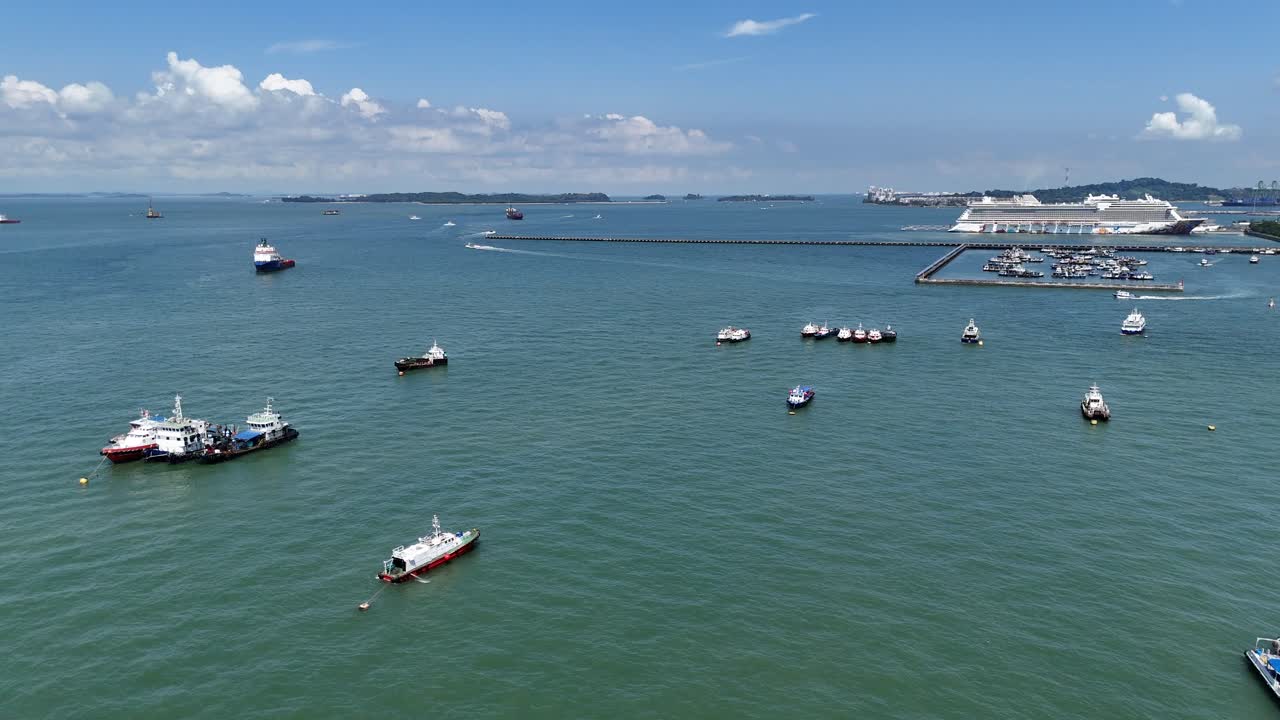 Drone aerial view of a fleet of cargo oil ships off the coast of singapore busy shipping lane global trade economy tankers