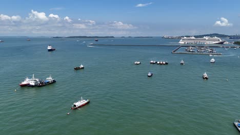 drone aerial view of a fleet of cargo oil ships off the coast of singapore busy shipping lane global trade economy tankers