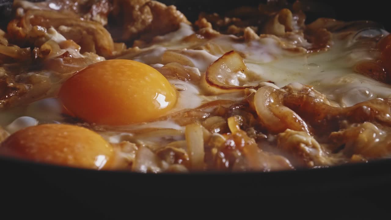 huevos y rodajas de cebolla fritos en una sartén, toma macro