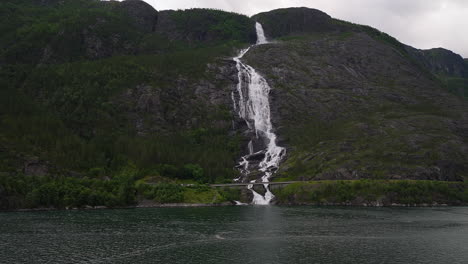 langfoss waterfall dropping down steep mountainside with great power