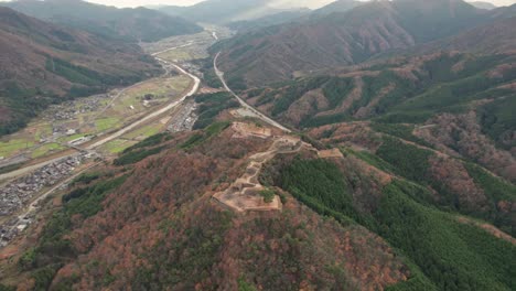 Aerial-Panoramic-Landscape-of-Japanese-Green-Mountain-Range-Takeda-Castle-Ruins-in-Hyogo,-Asago,-Morning-Skyline